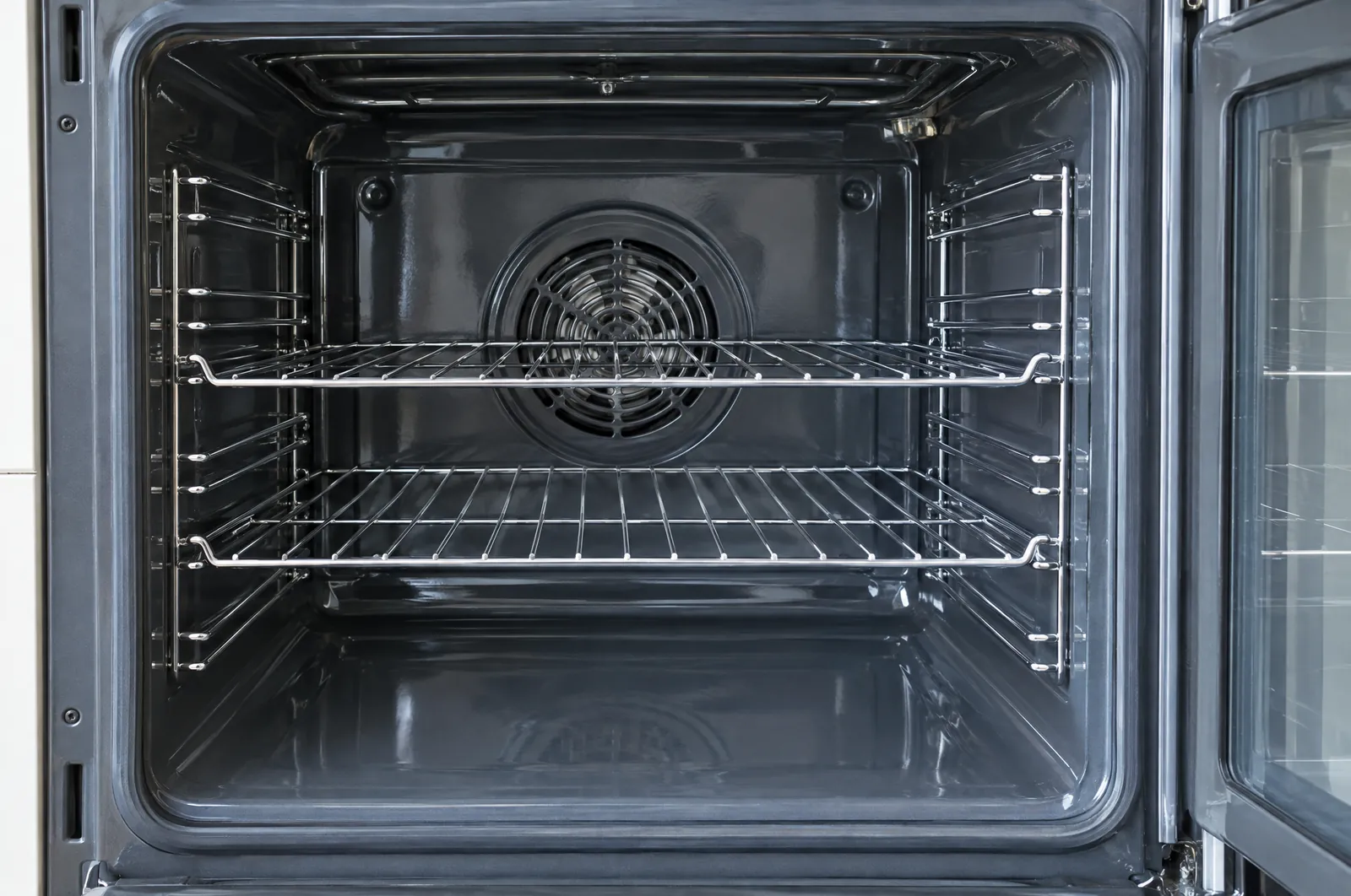 The same oven after cleaning: clean enamel and racks. Sample image.